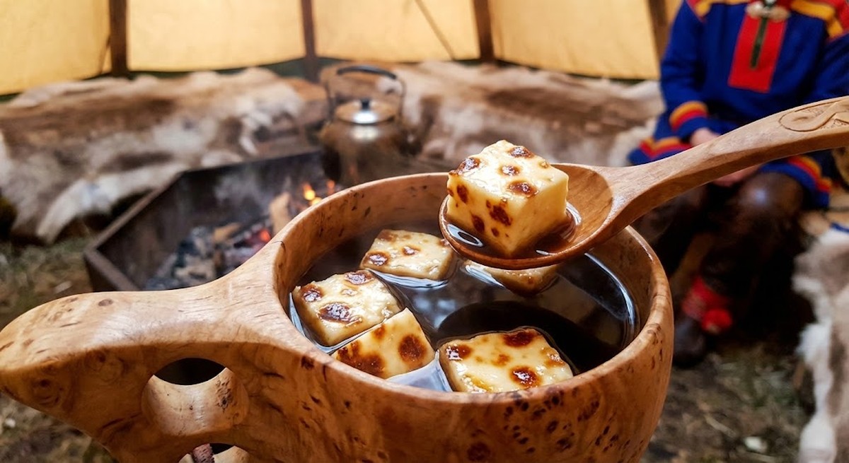 cubes of Leipäjuusto bread cheese soaking in cup of hot tea Sami tradition